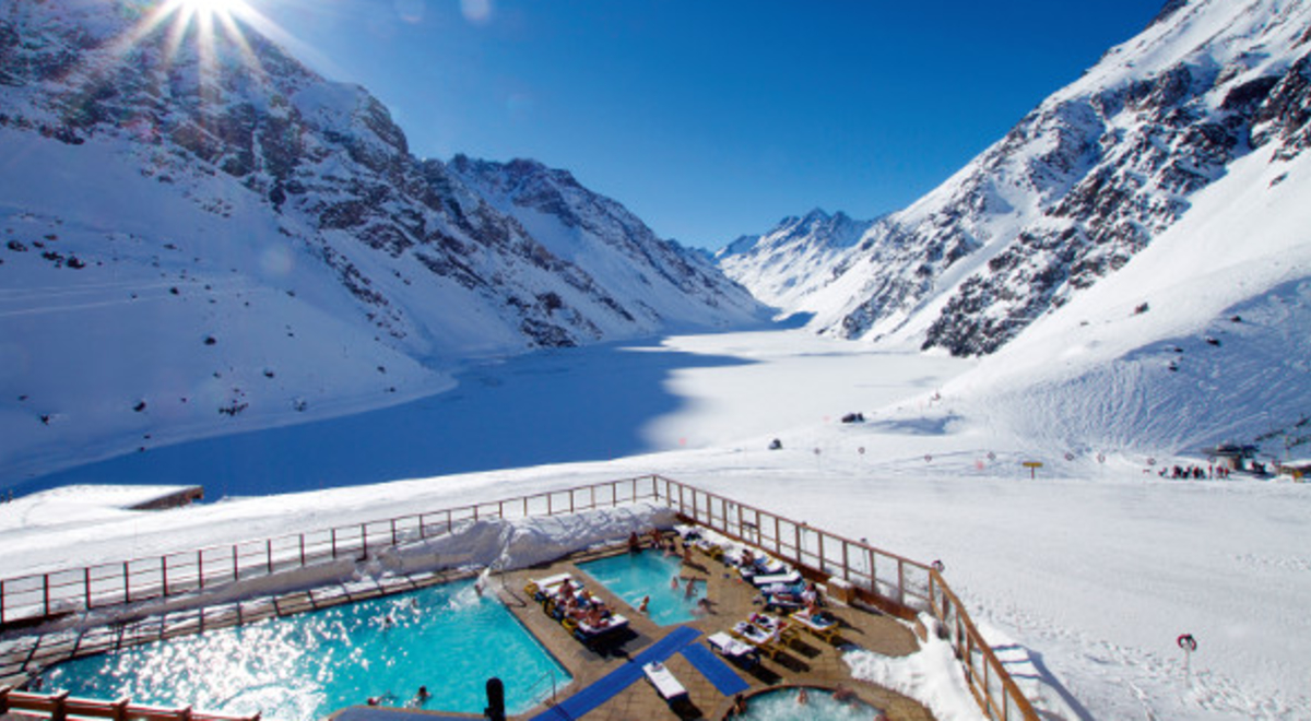 People lounge in a swimming pool beside a frozen lake in Portillo, Chile.