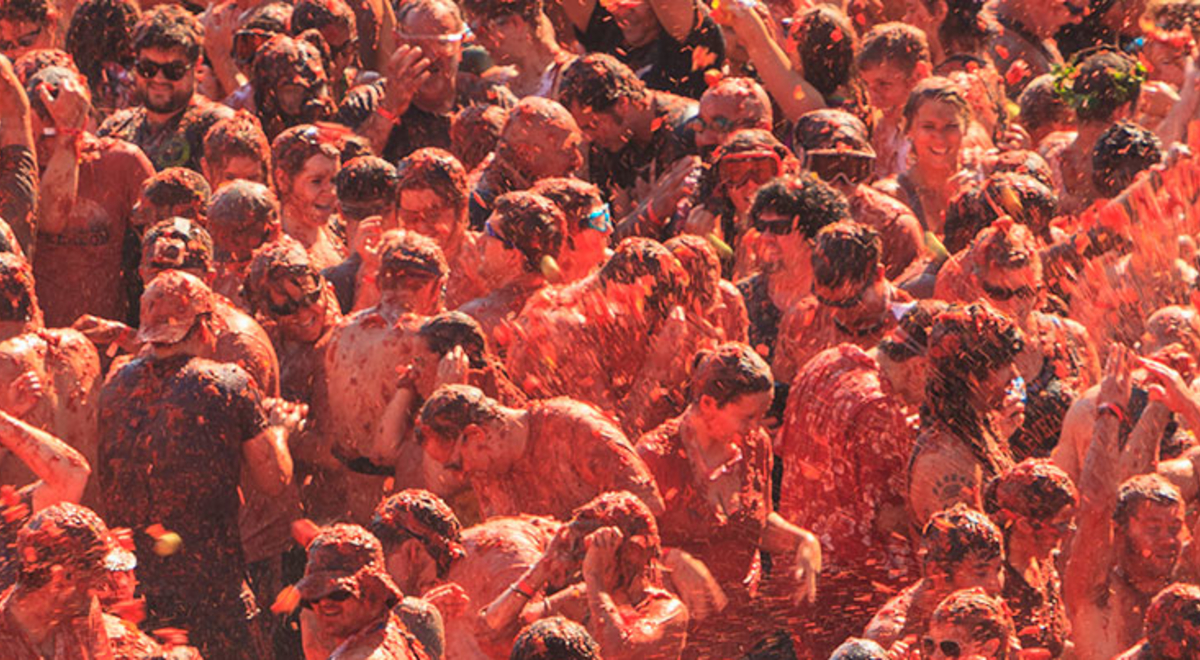 People throwing tomatoes at la tomatina festival in spain