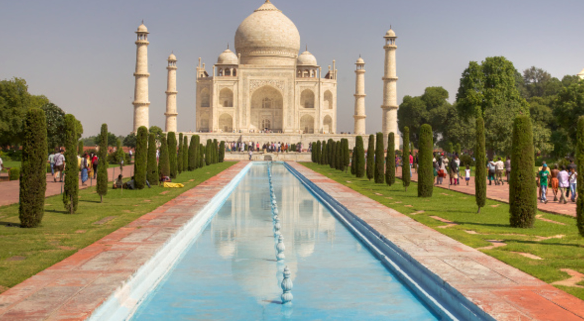 a pool in between the walkways toward the Taj Mahal building
