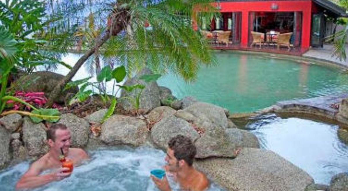 Two gentlemen enjoying jacuzzi in Turtle Cove Beach Resort while having a drink