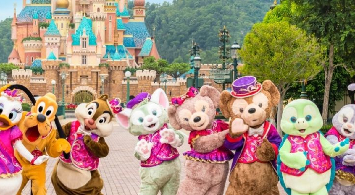 Disney characters at Hong Kong Disneyland in front of the Castle of Magical Dreams