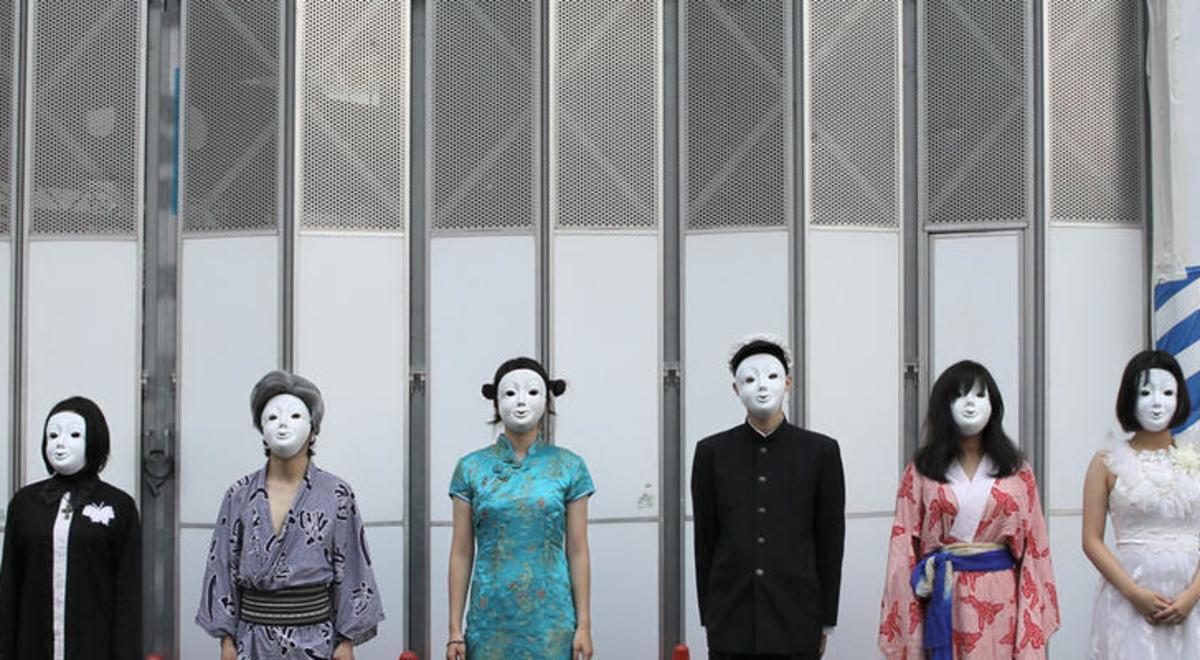 Ten men and women lined up with eight people wearing white masks 