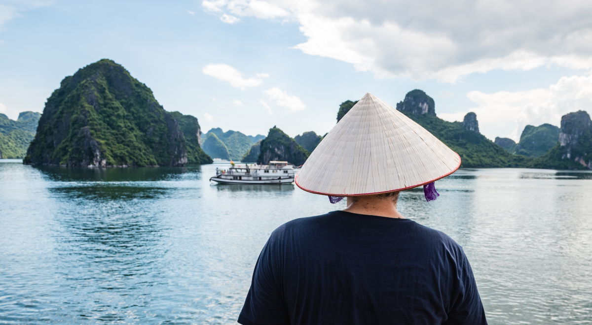 woman with Vietnamese hat on overlooking Halong Bay Vietnam