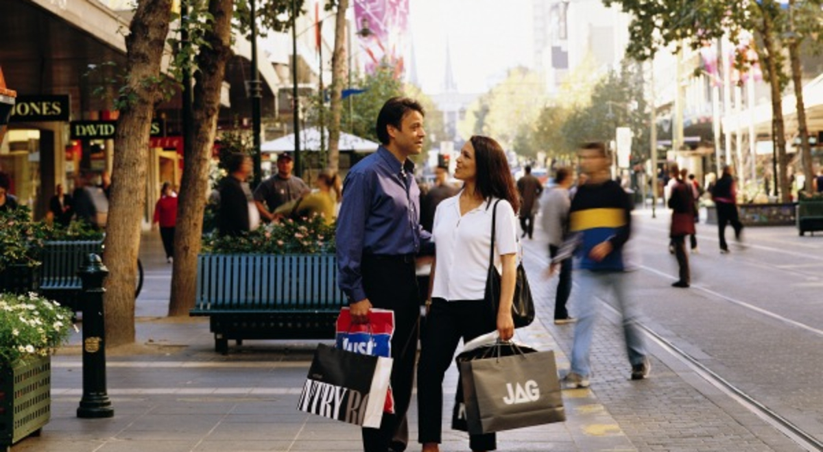 Couple standing on street holding shopping bags Melbourne
