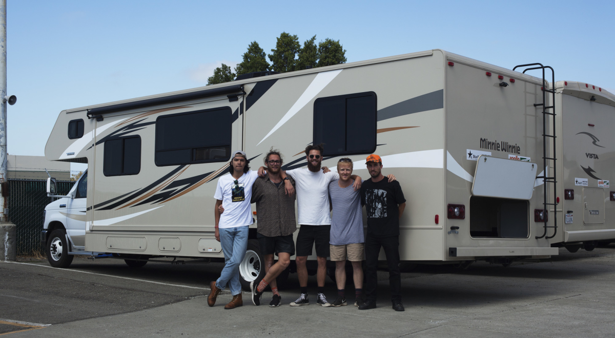 Group of people standing infront of RV