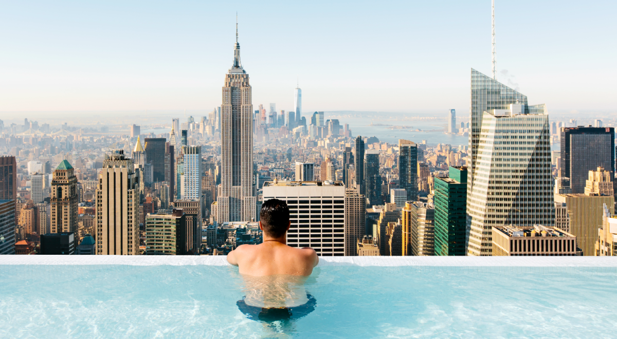 Man in rooftop infinity pool in NYC