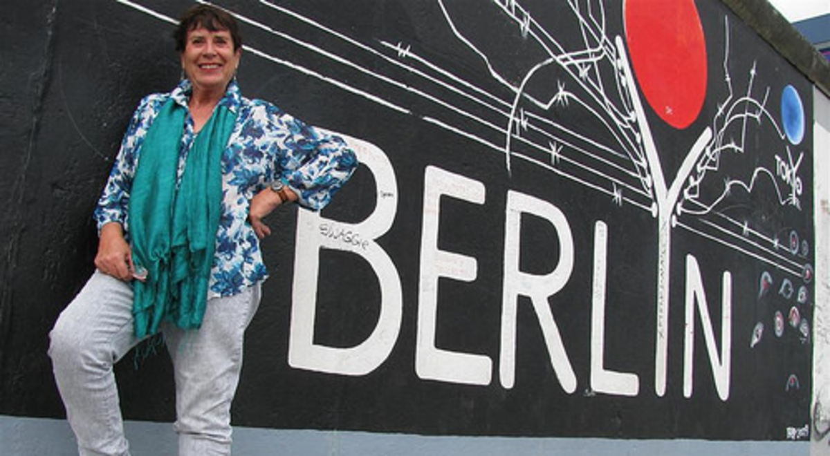 Lady standing in front of a wall labelled Berlin 
