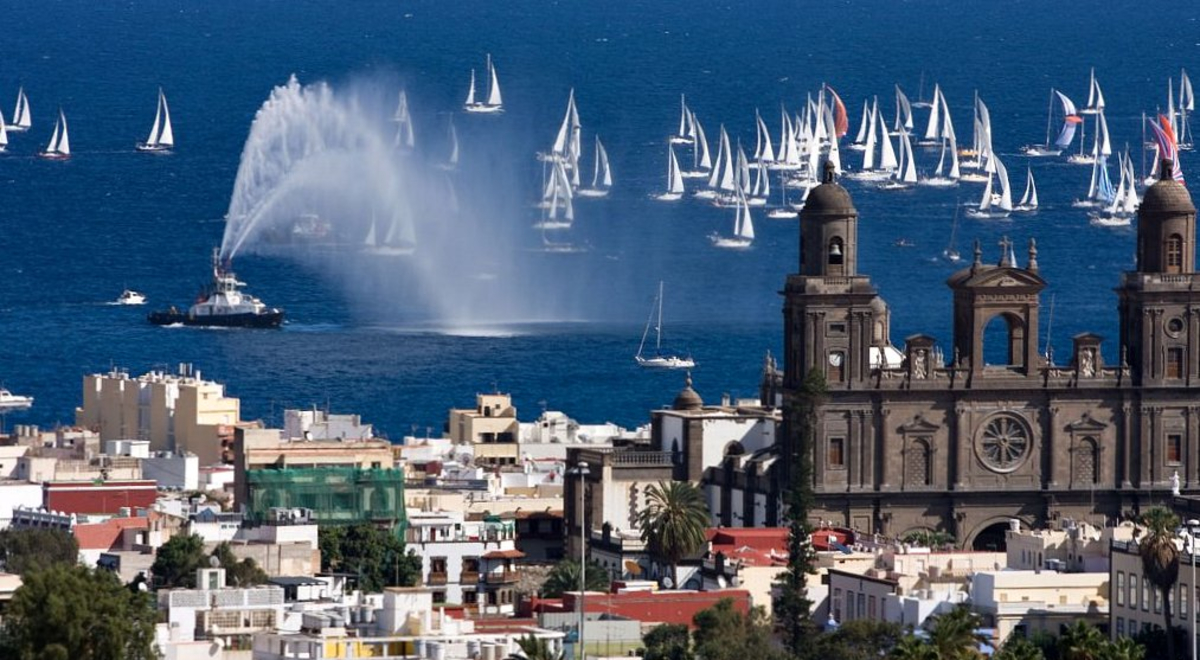 A old city with a tugboat spraying water in the background