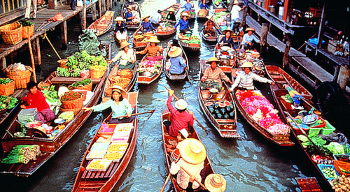 Boats containing produce and people in canal