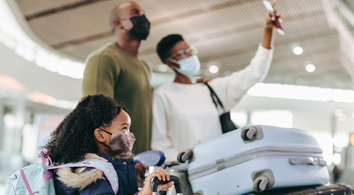 A family in the airport with their luggage