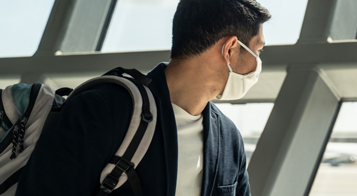 Middle aged man looking out to landed plane 