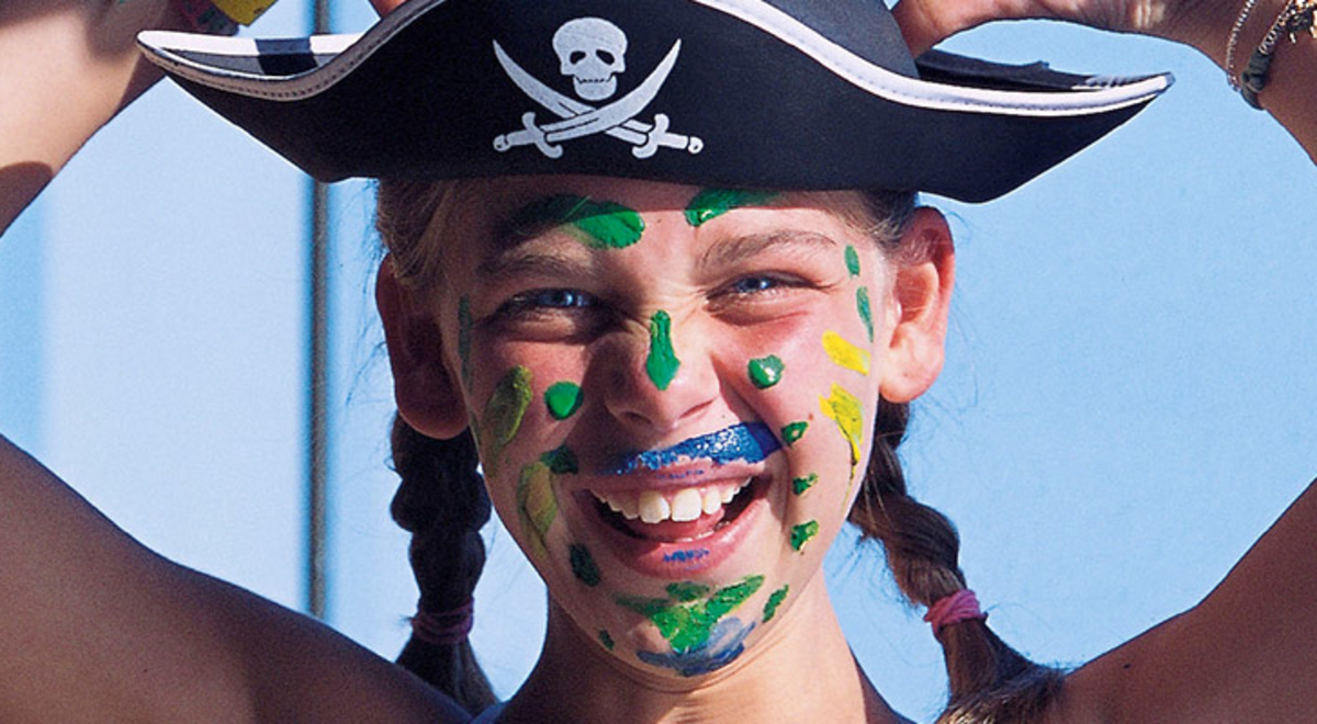 A child wearing a pirate hate and face paint