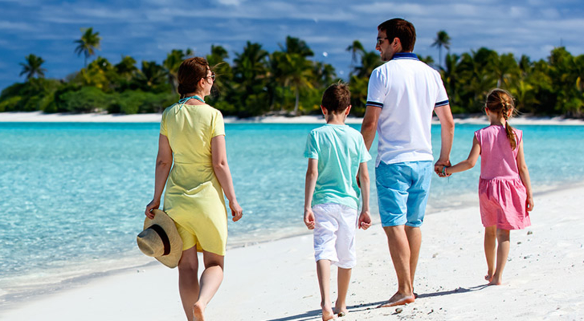 A family walking together along a beach in Mauritius