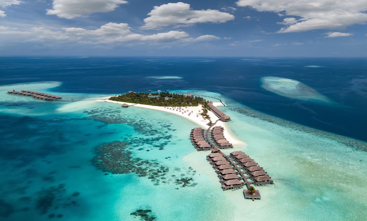 Overhead shot of multiple bungalows and a sandy island