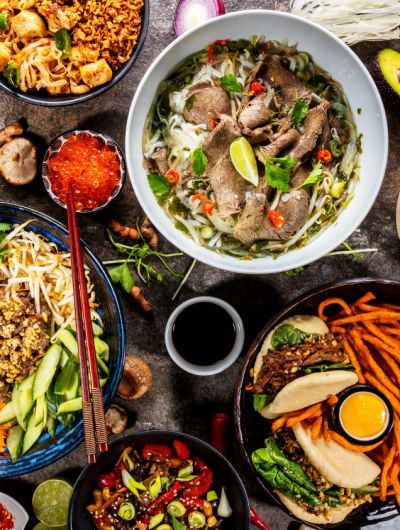 Vibrant Asian food spread out across a table.