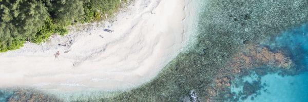 Aerial shot of the edge of an island and a reef