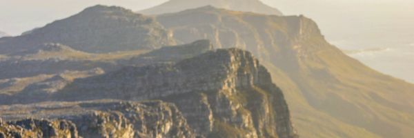 Lady standing at lookout holding binoculars