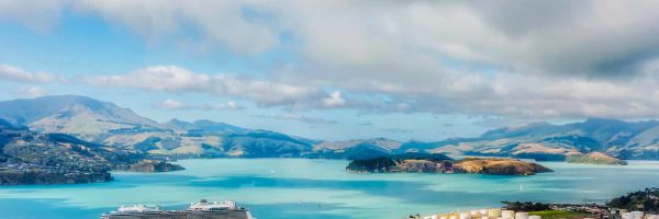 Cruise ship docked at Christchurch marina with mountainous background