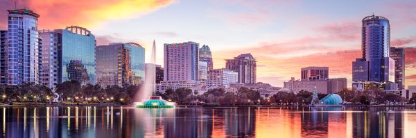 Orlando city under a pink and yellow sunset