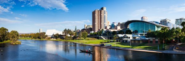 Green fields and hotels along a river on a bright day