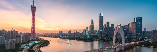 City skyline of Guangzhou at sunset, featuring Liede Bridge and Canton Tower