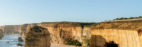 A man at a lookout admiring the view of the 12 apostles