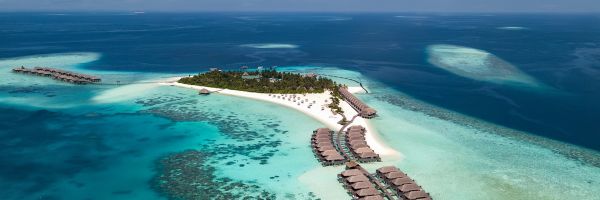 Overhead shot of multiple bungalows and a sandy island