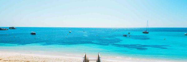 Boardwalk heading towards crystle blue water