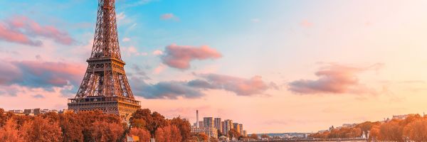Eifel Tower along the river with a stunning blue-pink sunset in the background