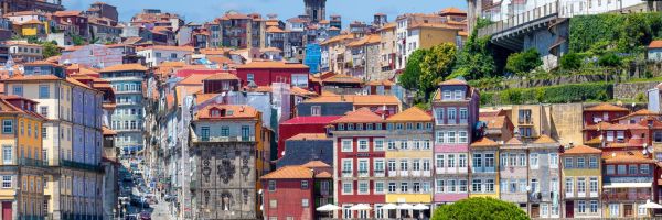 Porto Spain Connect - bright, tightly packed buildings framed by pink flowers