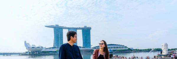 Couple on a walkway that looks out to Marina Bay Sands