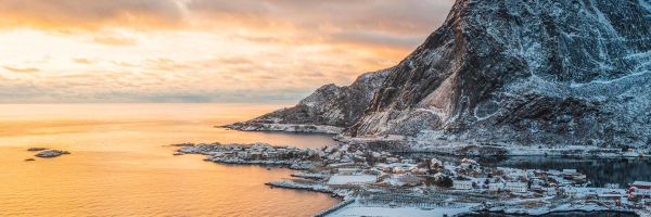 Cruise ship docked near snow-capped mountain