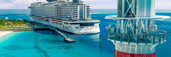 MSC cruise ship docked with lighthouse at the front of the image