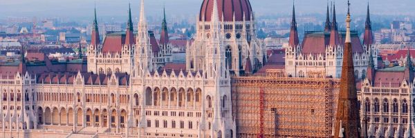 River ship cruising past Eastern Europe architecture 