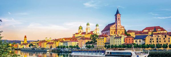 APT river ship cruising cruising past a small town