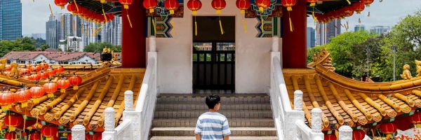 Young boy walking towards a shrine/temple