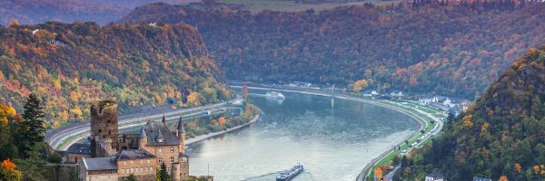 Drone ship of river ship cruising through Europe with sunset in background