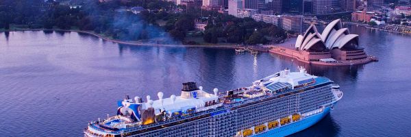 Drone shot of a Royal Caribbean ship docked in front of the Sydney Opera House