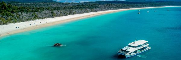 Drone shot of catmaran anchored up in shallow reef
