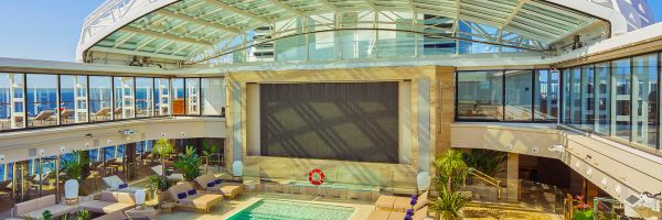Pool and sun loungers onboard cruise ship