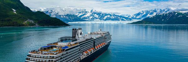 Cruise ship with snow-capped mountain in the distance