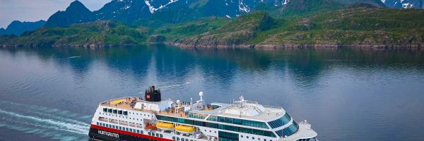 Cruise ship with mountain ranges in the background
