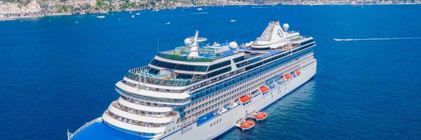 Cruise ship with cliff ranges in distance