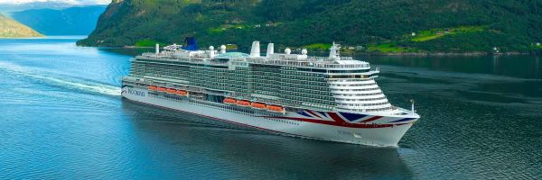 Cruise ship with green hills in background