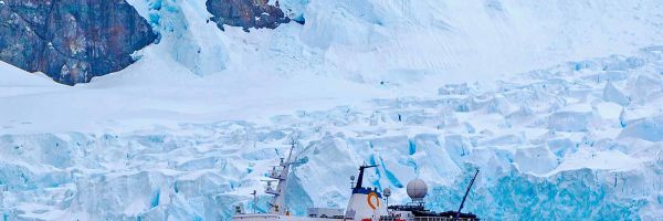 Cruise ship in front of a glacier