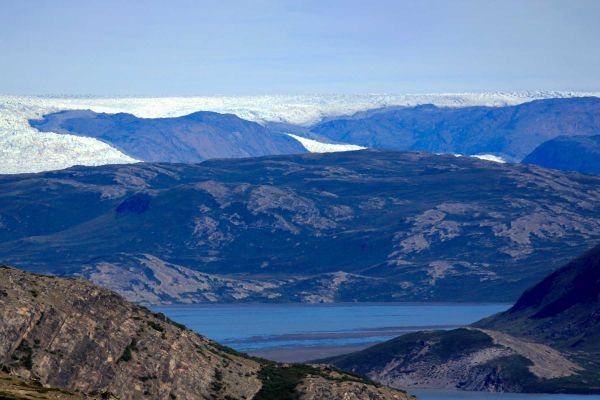 Mountainous range with lake in the distance