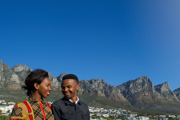 Two people smiling hands at lookout