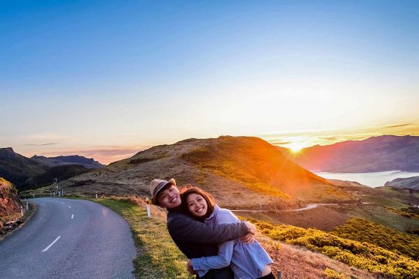Couple on side of road smiling
