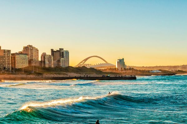 Surfer sitting on surf board in ocean