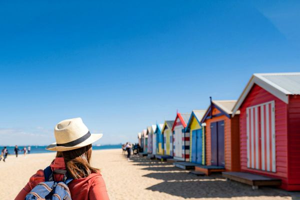 Lady on a beach admiring the Brighton bath boxes